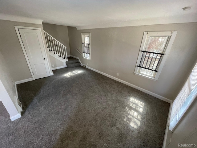 19254 Keystone St, Detroit, MI 48234 - unfurnished living room featuring stairs and dark colored carpet