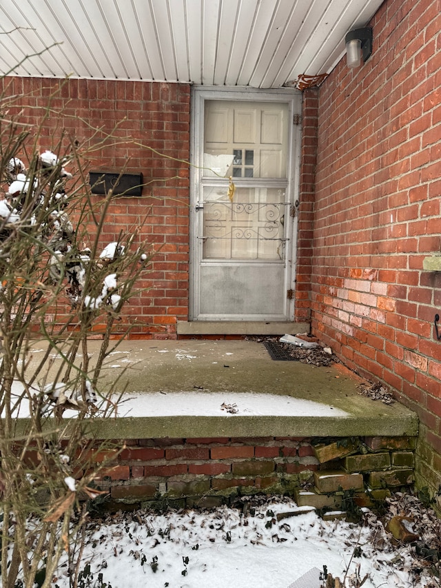 view of snow covered property entrance