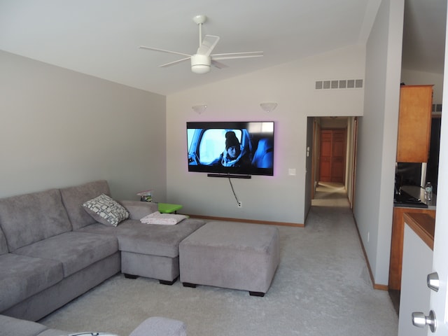 living room featuring vaulted ceiling, light carpet, and ceiling fan