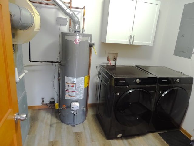 interior space featuring water heater, cabinets, electric panel, independent washer and dryer, and light hardwood / wood-style floors