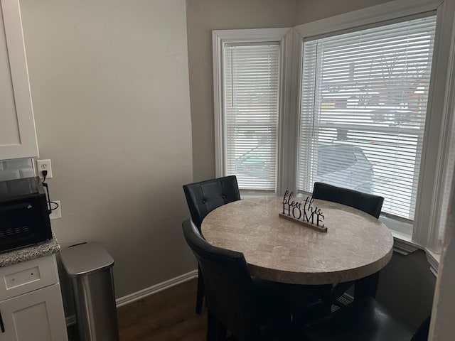 dining area with dark hardwood / wood-style floors