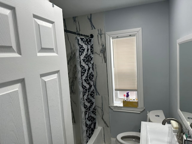 full bathroom with vanity, shower / bath combo, and toilet