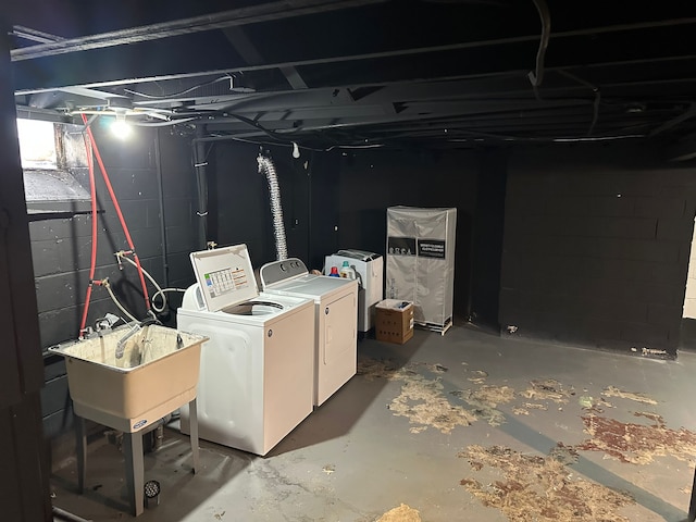 basement with sink and washing machine and dryer