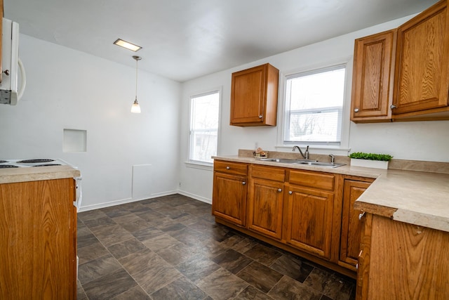 kitchen with a healthy amount of sunlight, sink, and pendant lighting