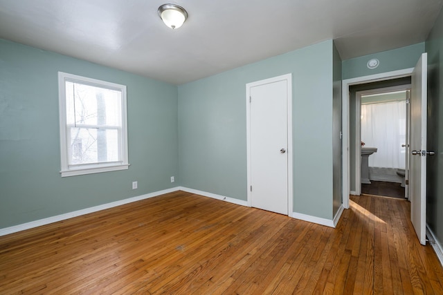 unfurnished bedroom with wood-type flooring and a closet