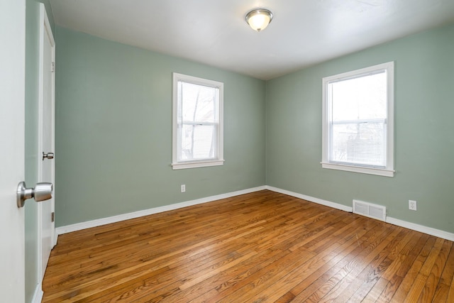 unfurnished room featuring hardwood / wood-style flooring