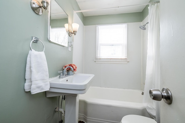 bathroom with shower / bath combination with curtain and toilet