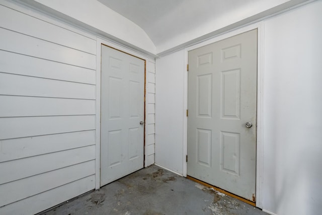 foyer with lofted ceiling and concrete flooring