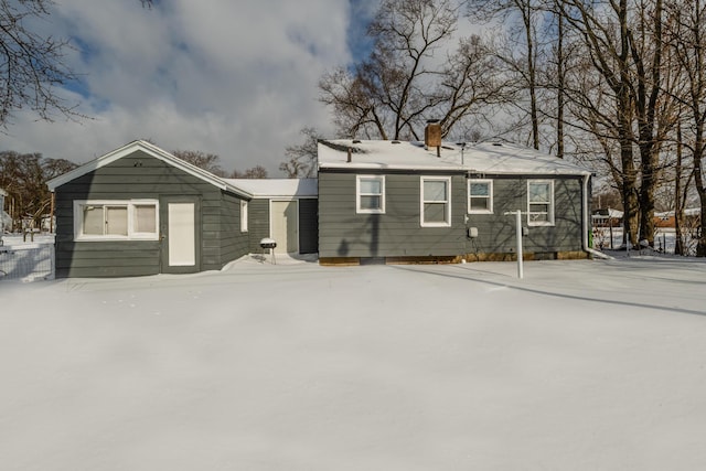 view of snow covered back of property