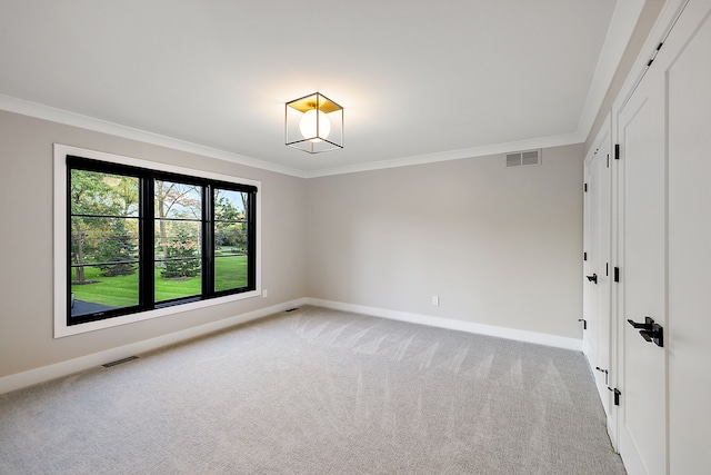 carpeted empty room featuring ornamental molding