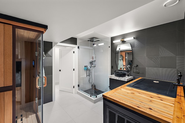 bathroom with vanity, tile patterned floors, and a shower with door