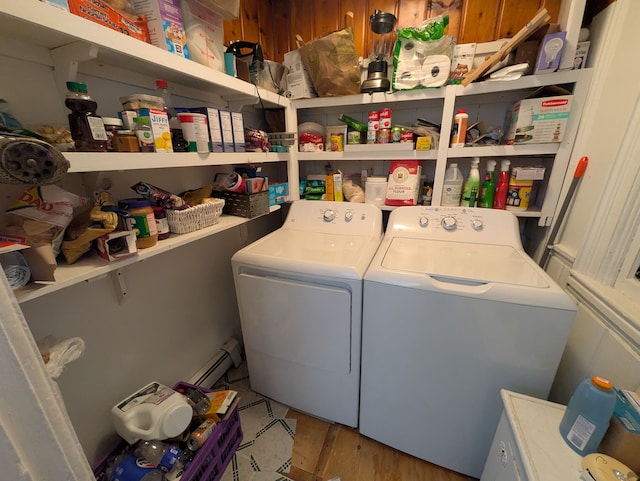 washroom with washing machine and dryer and a baseboard radiator