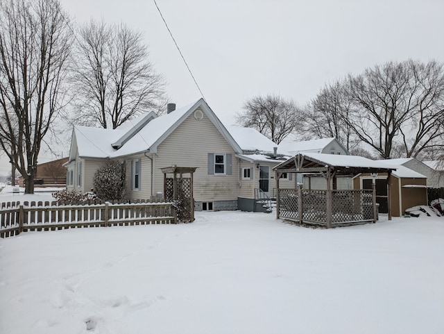 view of snow covered back of property