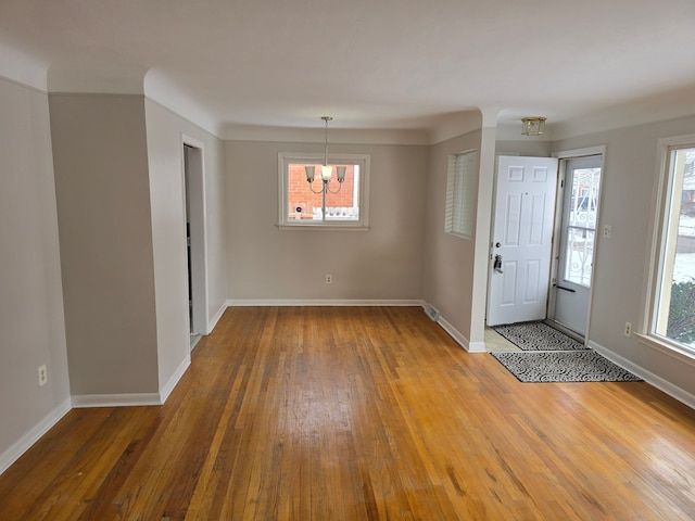 foyer featuring an inviting chandelier and wood-type flooring