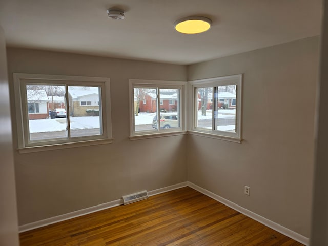 unfurnished room with hardwood / wood-style flooring