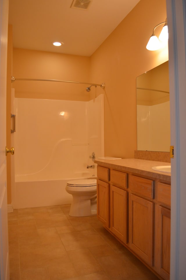 full bathroom with tile patterned flooring, vanity, washtub / shower combination, and toilet