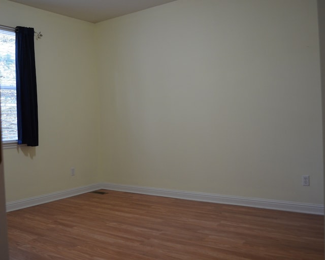 empty room featuring dark hardwood / wood-style floors