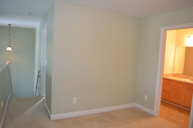 bedroom with sink and light carpet