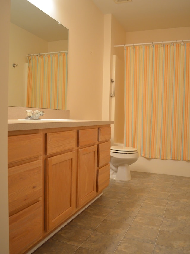 full bathroom with vanity, tile patterned flooring, toilet, and shower / bath combo with shower curtain