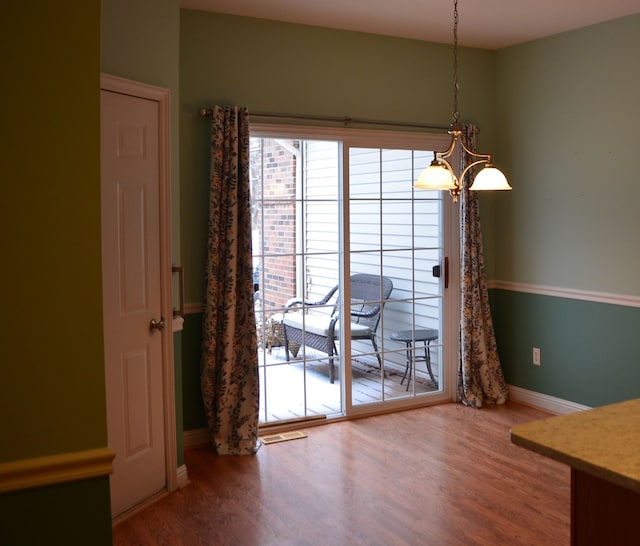 unfurnished dining area with hardwood / wood-style floors