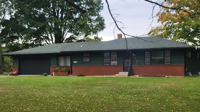 ranch-style home with a garage and a front lawn