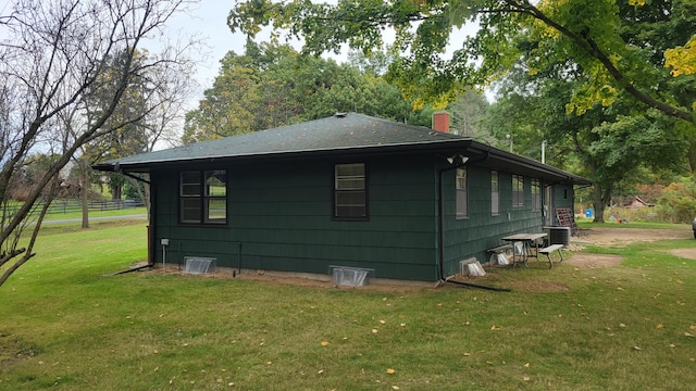 view of outdoor structure featuring a yard and central AC unit