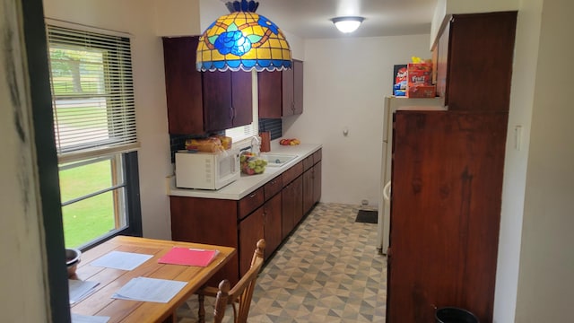 kitchen with dark brown cabinetry and sink