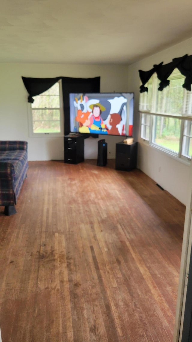 unfurnished living room with wood-type flooring