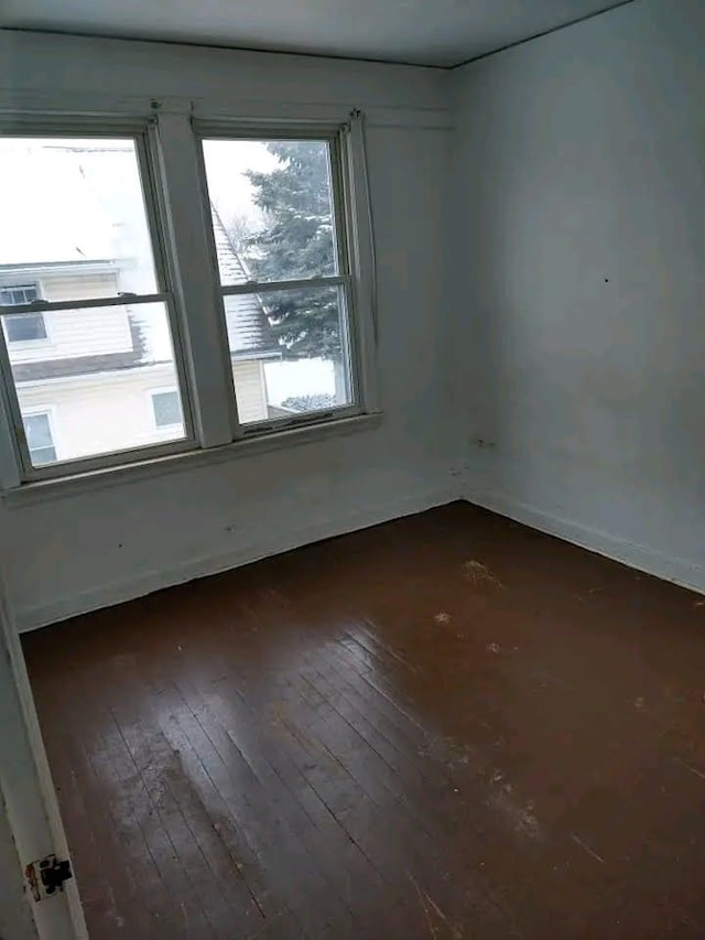 spare room with dark hardwood / wood-style floors