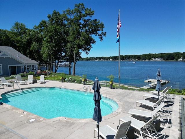 view of swimming pool with a water view and a patio area