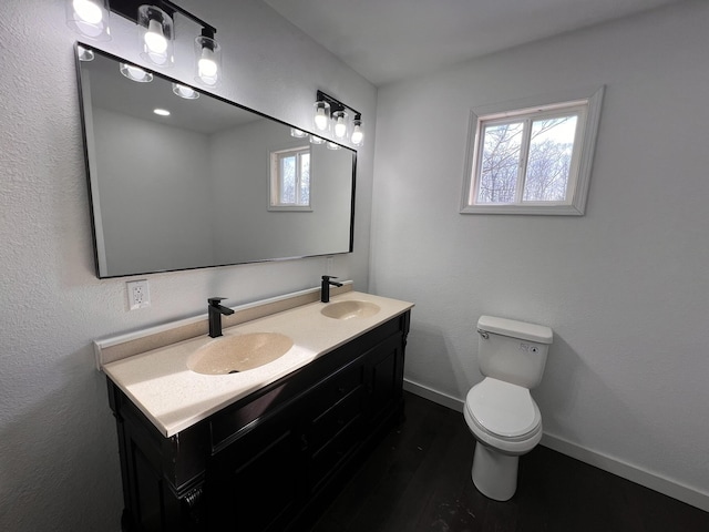 bathroom featuring hardwood / wood-style flooring, vanity, and toilet