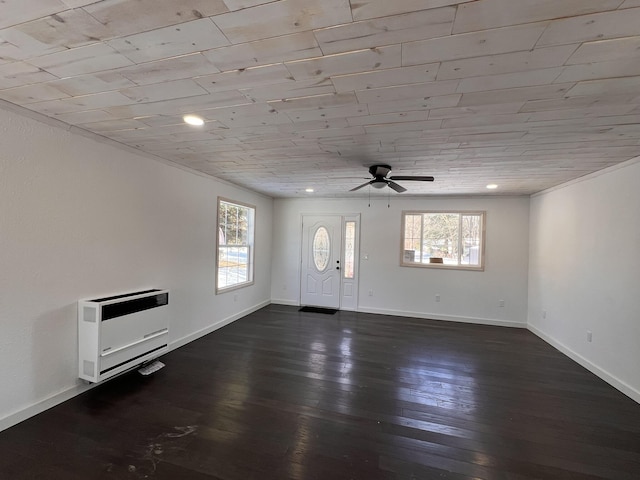 foyer entrance with dark wood-type flooring, ceiling fan, wood ceiling, and heating unit