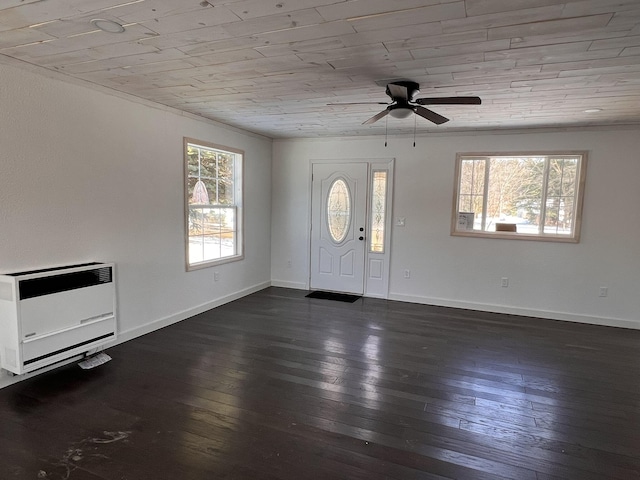 foyer entrance featuring wood ceiling, dark hardwood / wood-style flooring, heating unit, and a wealth of natural light