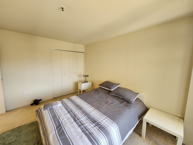 bedroom with carpet floors and a closet