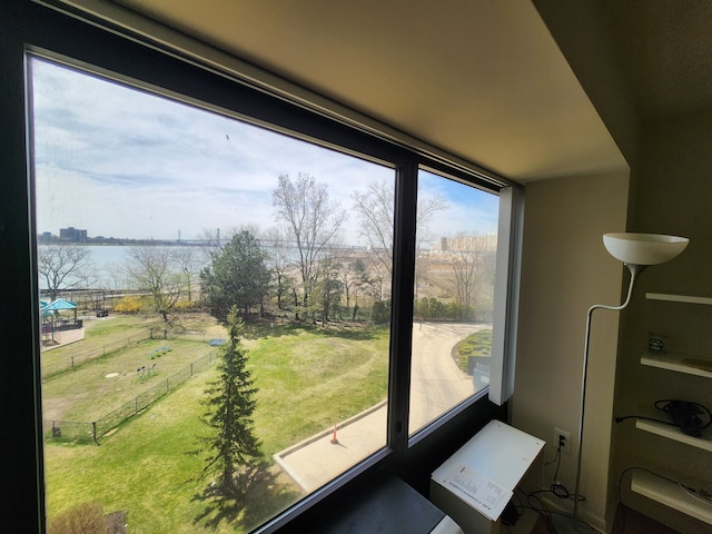 unfurnished sunroom with a water view