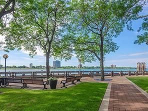 view of property's community featuring a water view and a lawn