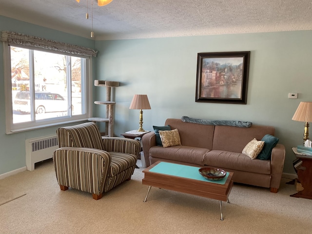 carpeted living room with radiator heating unit and a textured ceiling