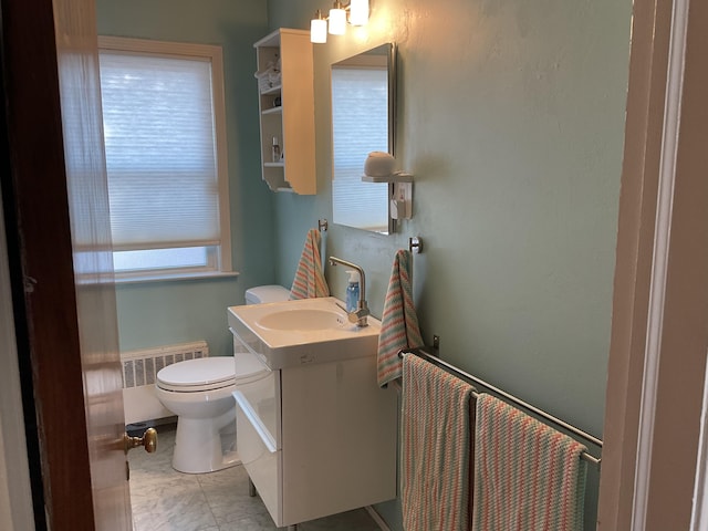 bathroom with tile patterned flooring, vanity, radiator, and toilet