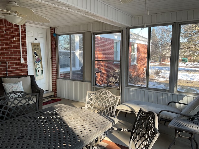 sunroom / solarium with ceiling fan and a healthy amount of sunlight