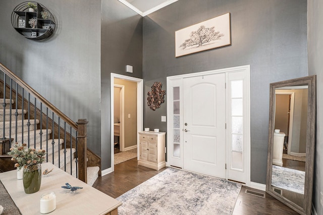 entryway featuring dark hardwood / wood-style floors and a high ceiling