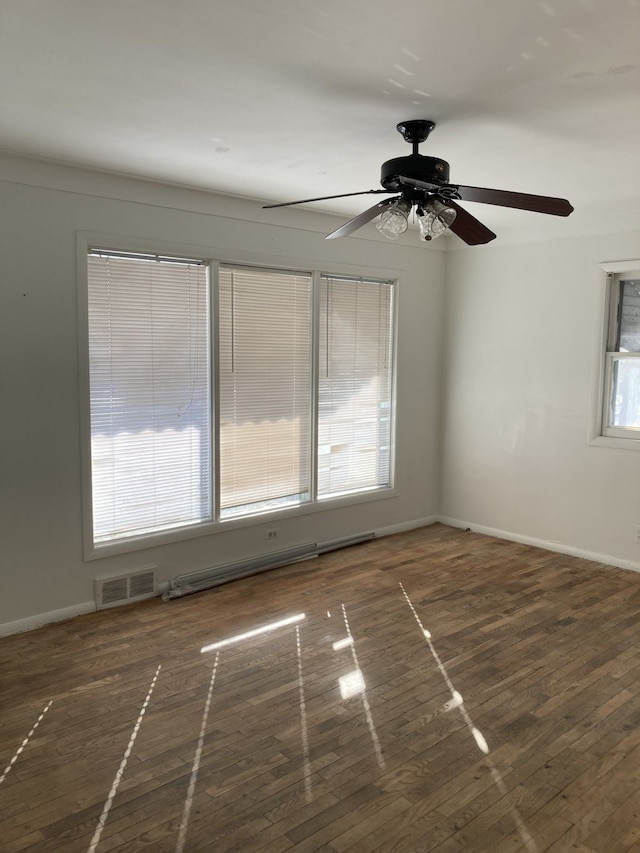 empty room with dark hardwood / wood-style flooring