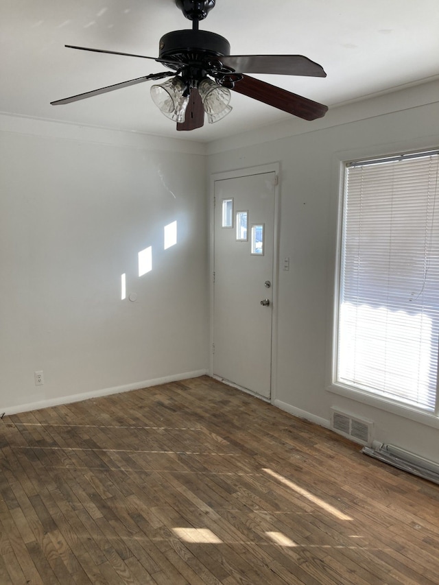 foyer entrance featuring dark wood-type flooring and ornamental molding