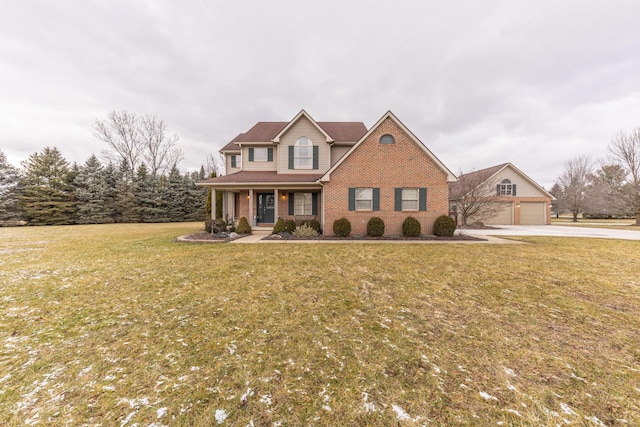 view of front of home featuring a garage, a front yard, and a porch