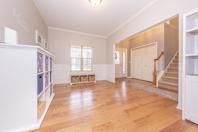 entryway featuring crown molding and light wood-type flooring