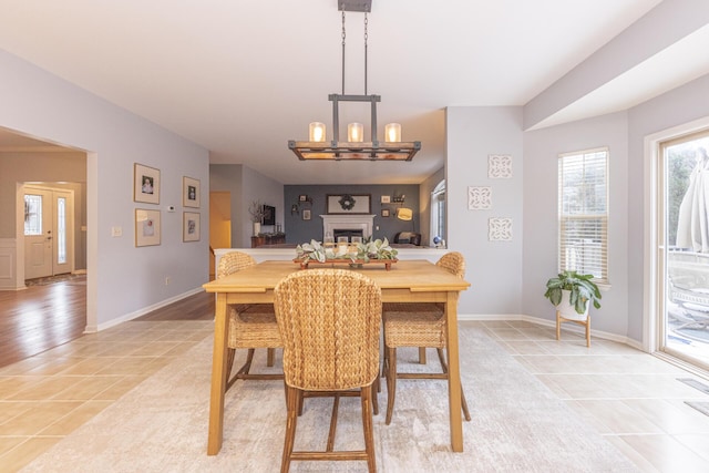 dining space featuring light tile patterned floors and a notable chandelier