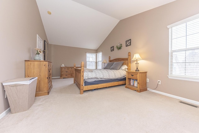 bedroom with lofted ceiling and light colored carpet