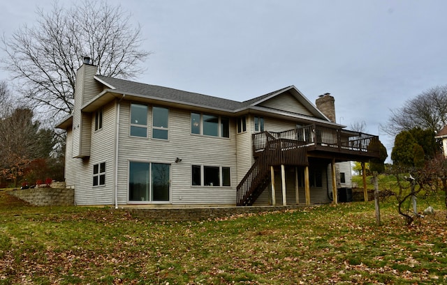 back of property featuring a wooden deck, a yard, and cooling unit