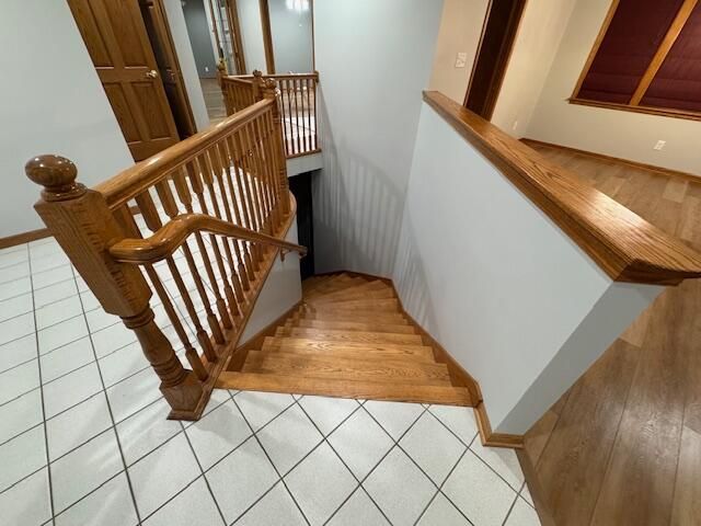 stairs with tile patterned floors