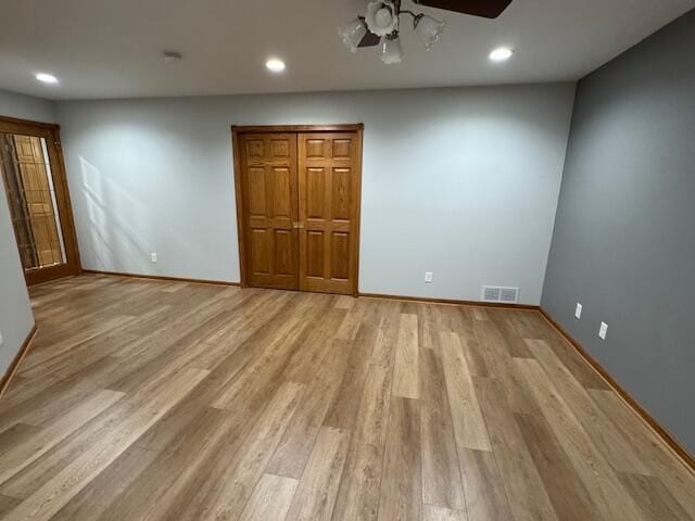 unfurnished bedroom with a closet, ceiling fan, and light wood-type flooring