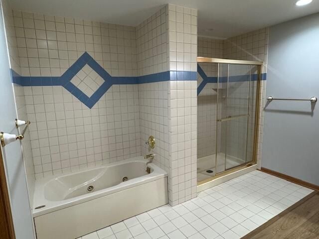 bathroom with independent shower and bath and tile patterned floors